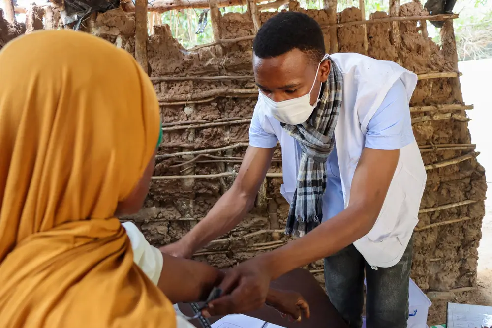 Un enfermero de MSF usa una mascarilla reutilizable en lugar de una mascarilla desechable, durante una consulta en Mozambique.