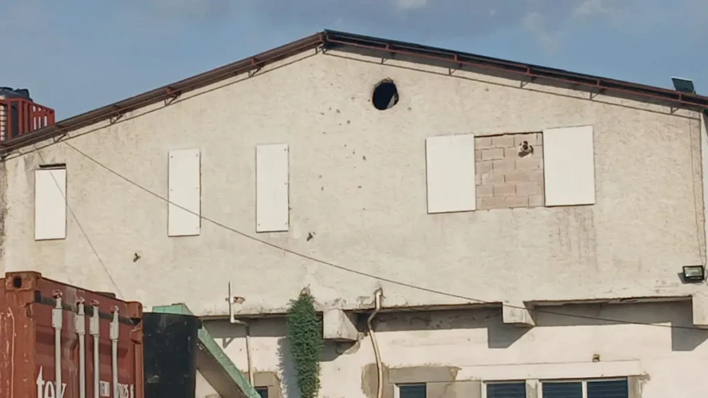 La violencia se intensificó cerca de la Maternidad Isaïe Jeanty en Cité Soleil, Puerto Príncipe, Haití, con balas impactando en las paredes.