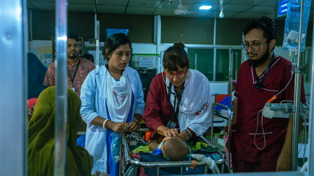 En el hospital de MSF en Kutupalong, un equipo médico encabezado por la doctora Dolores Echezarreta brinda atención de urgencia a Aiyan Arfan, un bebé de 10 días de nacido. El equipo trabaja conjuntamente para estabilizar el estado de salud del lactante. © Nazmul Islam/MSF