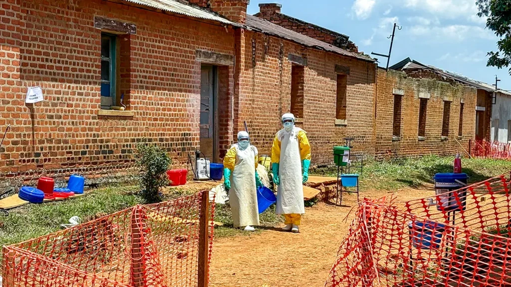 Dos trabajadores de la salud frente al Centro de Tratamiento de Ébola.