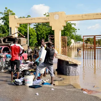 Las personas afectadas por las inundaciones en Nigeria cargan sus pocas pertenencias.